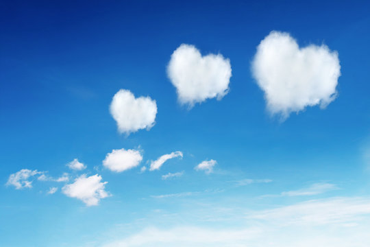 three heart shaped clouds on blue sky