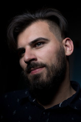 Obraz premium Attractive business man on dark studio background.
