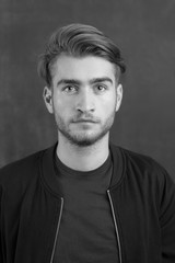 Portrait of a fashionable young man on dark background, chalkboa