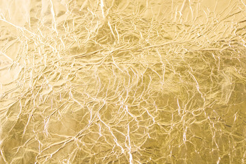 Gold wrinkled paper texture abstract background