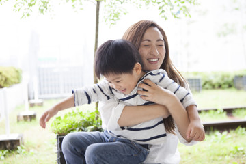Mom and son are playing in the park