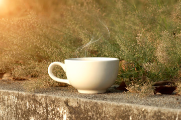 Coffee cup with small flower grass
