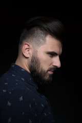 Portrait of the male over black background