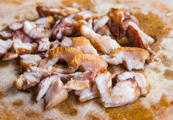 Close up slice of grill pork with knife on wood chop block in Th