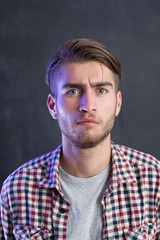 Fototapeta premium Portrait of a cheerful young man in checkered shirt
