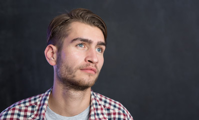 Obraz premium Portrait of a cheerful young man in checkered shirt