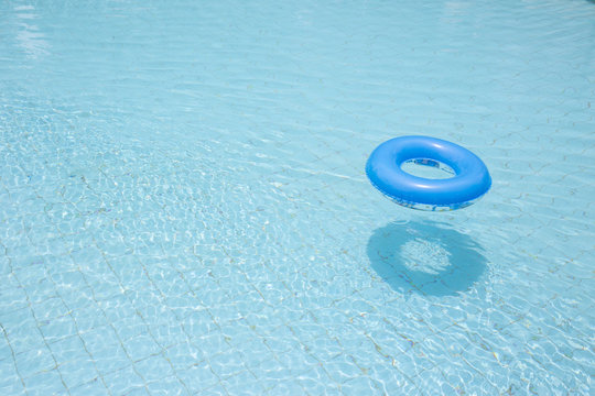 blue swim ring for children flip over and float on swimming pool
