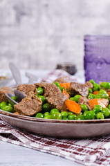 Meat stew with peas and carrots