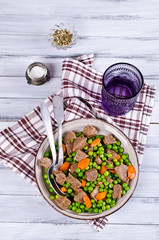 Meat stew with peas and carrots