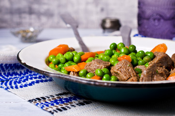 Meat stew with peas and carrots