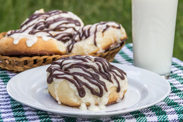 Homemade cinnabons cinnamon buns with cream cheese glaze and chocolate icing