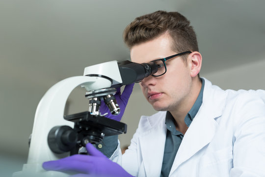 young doctor scientist in bright labaratory work research and an