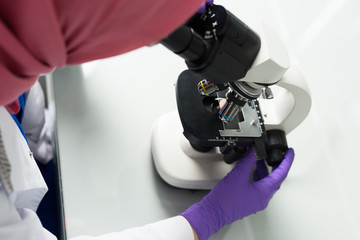 muslim lab worker with hijab or researcher doing an analysis in