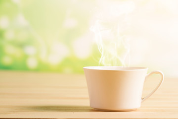 Coffee cup and smoke background green nature bokeh.