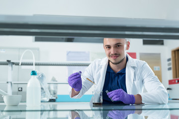 Cheerful young researchers are working in lab