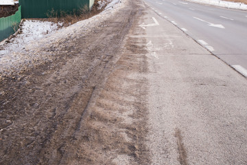 Very dirty snow on the roadside. Environmental pollution along the roads in the winter time