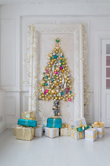 Beautiful interior living room decorated for Christmas. Big mirror frame with a tree made of balls and toys