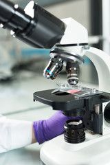 Scientist hands with microscope close-up shot in the laboratory