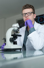 Portrait of caucasian male chemist scientific researcher using m