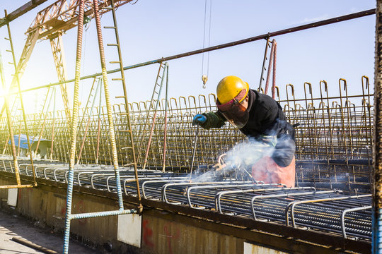 In the construction site, the welding workers at work