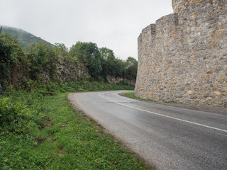 Fototapeta na wymiar Road near the old castle wall