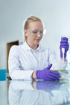 doctor female researcher holding up a test tube in labaratory