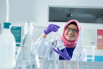 muslim lab worker with hijab or researcher doing an analysis in