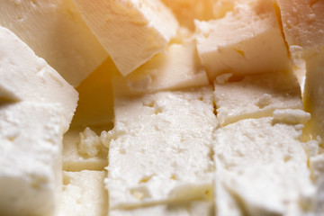 Pieces of feta cheese, background. Toned