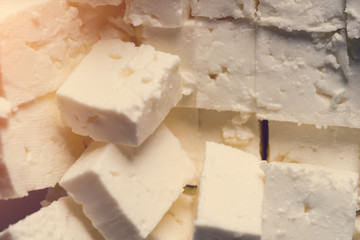 Pieces of feta cheese, background. Toned