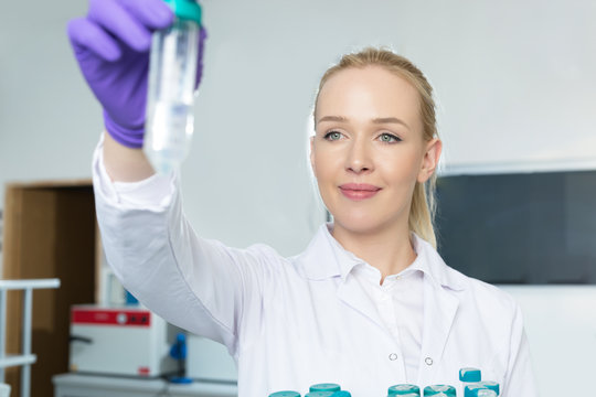 doctor female researcher holding up a test tube in labaratory