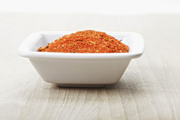 Dish with spice mixture for fish courses on wood