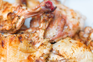 Appetizing fried chicken legs on the grill, background