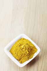 Grounded khmeli suneli spice mixture on wood