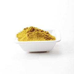 Dish with khmeli suneli spice mixture on tablecloth