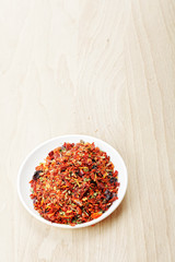 Saucer with spice mixture for rice courses on wood