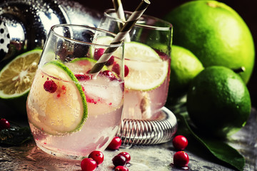 Cranberry lemonade with lime and ice, metallic background, selec