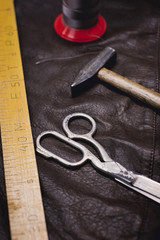 Tools pattern. Hammer, ruler, scissors in leather. Background with sewing and knitting tools and accesories.