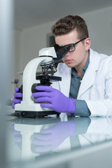 Portrait of caucasian male chemist scientific researcher using m