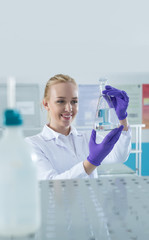 Fototapeta premium Portrait of a female researcher doing research in a lab
