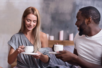 Joyful couple eating together in the morning