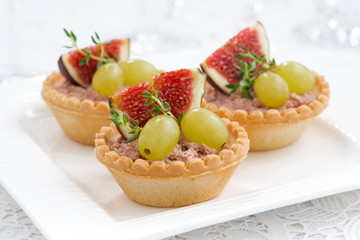 tartlets with liver pate and fruit on plate
