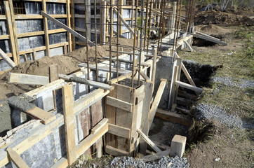  Fresh concrete in wooden concrete formwork,closed up steel bars reinforcement column on concrete foundation