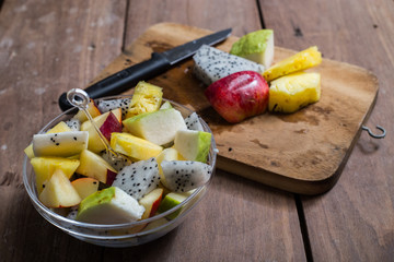 Fruit salad on wood background