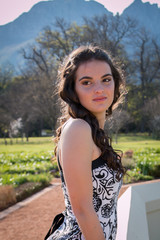 Naklejka premium Brunette model with black and white dress portrait.