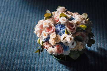 Wedding bouquet of yellow and blue roses lying on the floor