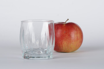 Apple with empty glass 