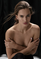 Naklejka premium Nude woman posing in studio , in black tights
