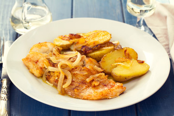 fried cod fish with potato on white plate