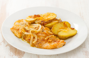 fried cod fish with potato on white plate