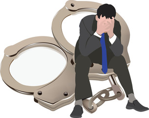 persona disperata seduta sopra  le manette